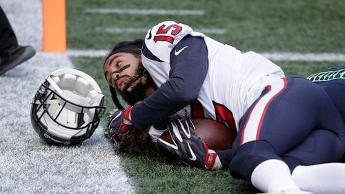 Houston Texans wide receiver Will Fuller loses his helmet after a reception for a touchdown against the Seattle Seahawks in the first half of an NFL football game, Sunday, Oct. 29, 2017, in Seattle. (AP Photo/Elaine Thompson)