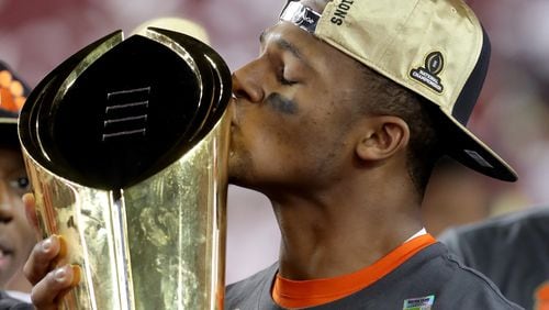 Quarterback Deshaun Watson of the Clemson Tigers celebrates with the College Football Playoff National Championship Trophy after defeating the Alabama Crimson Tide 35-31 to win the 2017 College Football Playoff National Championship Game  in 2017. Local teachers will get a chance to snap a photo with the trophy Saturday, before the championship game comes to Atlanta.