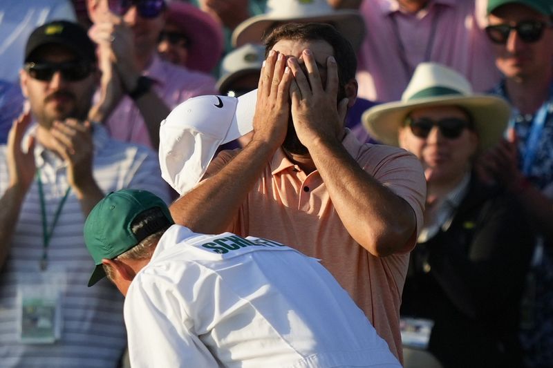 Scottie Scheffler celebrates his win at the Masters golf tournament at Augusta National Golf Club Sunday, April 14, 2024, in Augusta, Ga. (AP Photo/Matt Slocum)