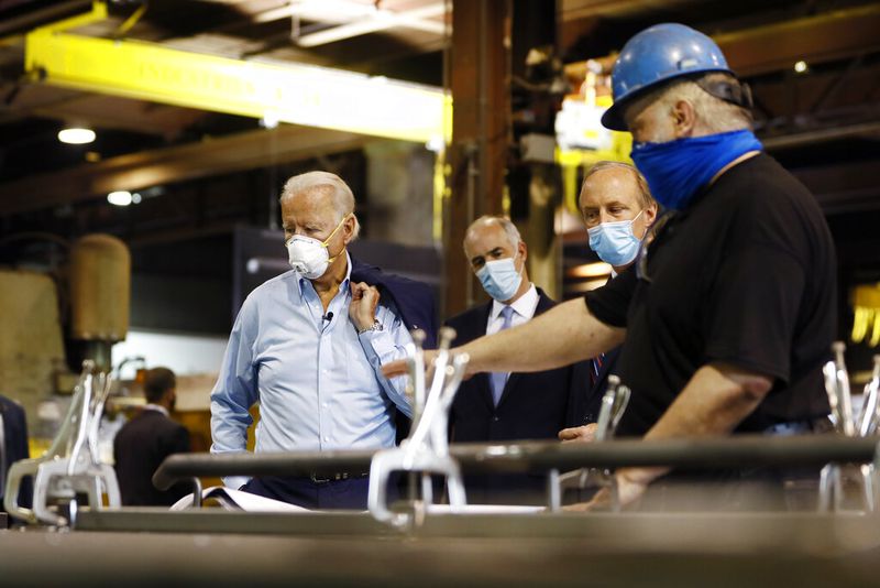 FILE - In this July 9, 2020, file photo Democratic presidential candidate, former Vice President Joe Biden, from left, Sen. Bob Casey, D-Pa., and McGregor Industries owner Bob McGregor listen to First Class Fitter Michael Phillips during a tour of the metal fabricating facility in Dunmore, Pa. Biden is pledging to define his presidency by a sweeping economic agenda beyond anything Americans have seen since the Great Depression and the industrial mobilization for World War II. (AP Photo/Matt Slocum, File)