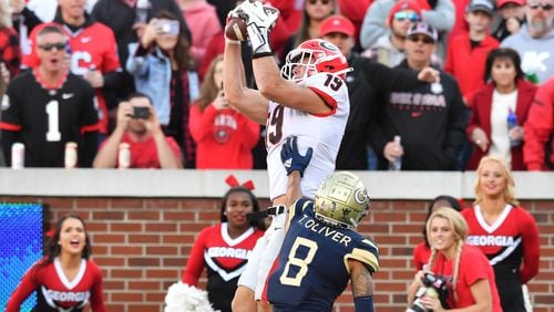 Georgia's tight end Brock Bowers (19) makes a touchdown pass over Georgia Tech's defensive back Tobias Oliver (8) during the second half of an NCAA college football game at Georgia Tech's Bobby Dodd Stadium in Atlanta on Saturday, November 27, 2021. Georgia won 45-0 over Georgia Tech. (Hyosub Shin / Hyosub.Shin@ajc.com)