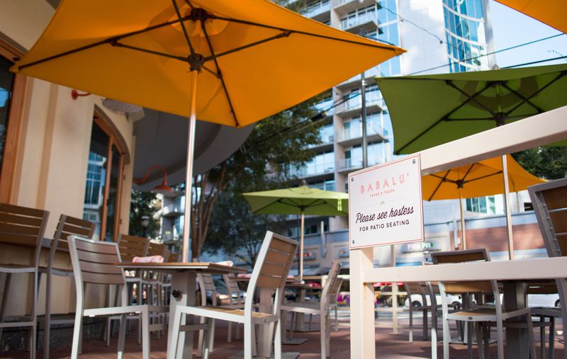 Colorful umbrellas decorate the patio at Babalu, which overlooks the intersection of West Peachtree and Peachtree Place in Midtown. CONTRIBUTED BY HENRI HOLLIS