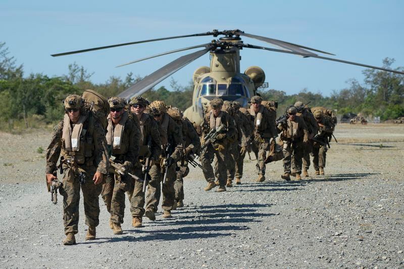 U.S. troopers prepare to board U.S. Army CH-47s at Paredes Air Station at Pasuquin, Ilocos Norte province as it carries U.S. and Philippine troops during a joint military exercise in northern Philippines on Monday, May 6, 2024. American and Filipino marines held annual combat-readiness exercises called Balikatan, Tagalog for shoulder-to-shoulder, in a show of allied military readiness in the Philippines' northernmost town facing southern Taiwan. (AP Photo/Aaron Favila)