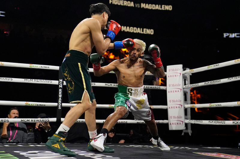 Brandon Figueroa lands a left to Jessie Magdaleno in a featherweight title fight Saturday, May 4, 2024, in Las Vegas. (AP Photo/John Locher)