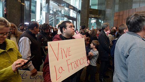Marc Jamali of Atlanta holds a sign in solidarity with the Paris victims. A crowd of about 400 people gathered at the French Consulate in Atlanta on Sunday, Nov. 16, during a rally in support of the victims of the Paris terrorist attack. After brief remarks, the crowd sang "La Marseillaise," the French national anthem.