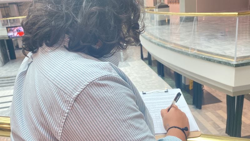 Councilmember Liliana Bakhtiari signs the petition for a referendum on the planned public safety training center. More than 70,000 signatures need to be collected from registered Atlanta voters to get on the ballot.