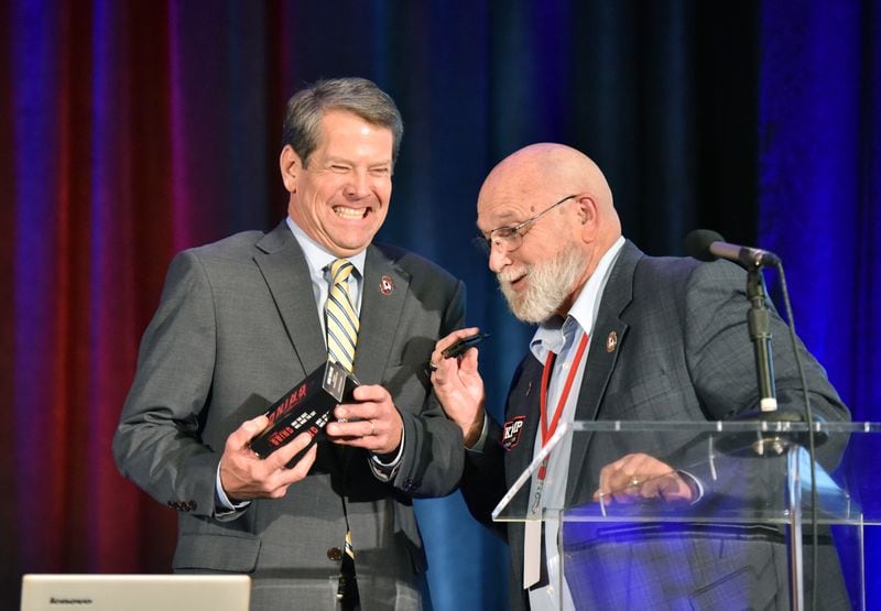 August 25, 2018 Stone Mountain - Republican candidate for Georgia governor Brian Kemp (left) and Jerry Henry, Executive Director of Georgia Carry, share a laugh as Jerry Henry presents a folding knife during Georgia Carry's 19th Annual Convention at Atlanta Evergreen Marriott Conference Resort in Stone Mountain on Saturday, August 25, 2018. HYOSUB SHIN / HSHIN@AJC.COM