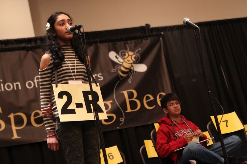March 17, 2017, Atlanta, Georgia -Jahnvi Bhagat (left), from Daniell Middle School in Cobb County, stands and begins to spell a word in one of the final rounds of competition in the State Spelling Bee in Atlanta, Georgia, on March 17, 2017. Bhagat would go on to place second overall as the alternate to Abhiram Kapaganty (right). (HENRY TAYLOR / HENRY.TAYLOR@AJC.COM)