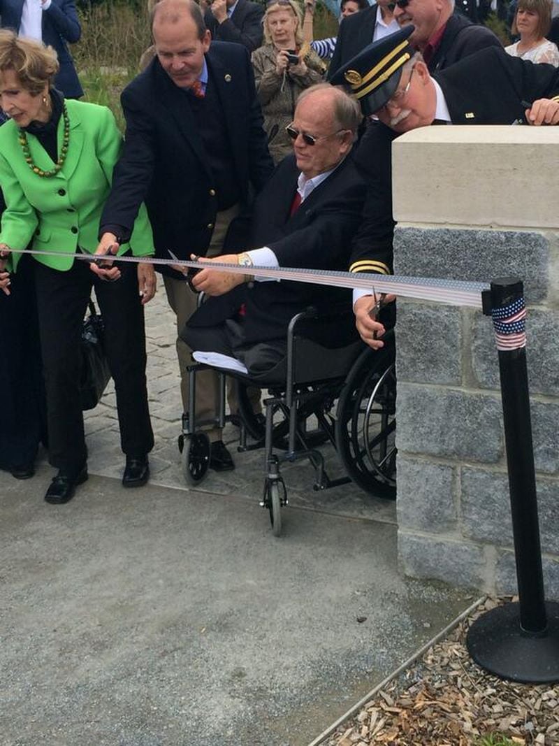 Former Georgia Sen. Max Cleland, who is currently secretary of the American Battle Monuments Commission, cuts the ribbon at the new visitors center in Pointe du Hoc in Normandy as part of ceremonies for the 70th anniversary of D-Day on Thursday, June 5, 2014.