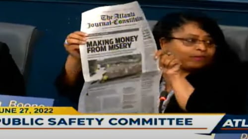 Councilwoman Andrea Boone, whose district covers much of southwest Atlanta, holds up a copy of the AJC's June 15 newspaper that features part of the Dangerous Dwellings investigation.