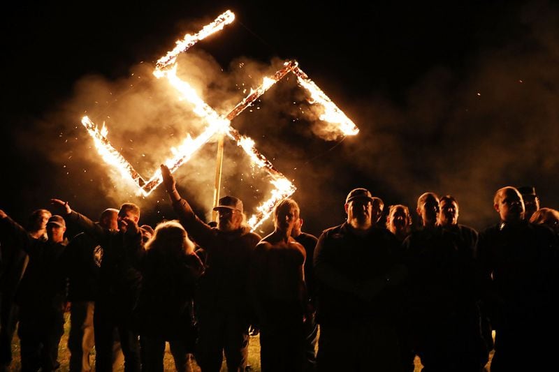 Members of the National Socialist Movement, a neo-Nazi group, hold a swastika-burning in Draketown, Ga., on April 21, 2018, following their rally that day in Newnan, Ga. (Photo by Spencer Platt/Getty Images)