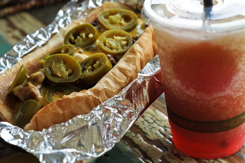 The Hot Mess Slinger- Link Sausage, chili, Wild Heaven cheese sauce and jalapenos -- at Delia's Chicken Sausage Stand, served with a Swirlie -- 1/2 frozen raspberry lemonade & 1/2 frozen sweet tea. (BECKY STEIN/special)