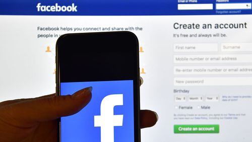 Some users say Facebook is posting their old photos like new ones and without their permission. (Photo by Carl Court/Getty Images)
