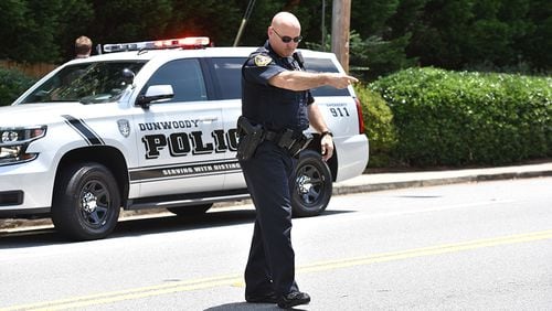 In addition to making examples of 19-year-olds who post their wrongdoings on Facebook, the Dunwoody Police Department enforces speed limits to protect pedestrians. Here, Officer Christopher Irwin tells an alleged speeder to pull over to the side of the road.