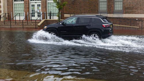 A sport utility vehicle moves down a flooded street in Ventnor, N.J., Friday, July 10, 2020. Fast-moving Tropical Storm Fay made landfall in New Jersey on Friday amid heavy, lashing rains that closed beaches and flooded shore town streets. (Kristian Gonyea/The Press of Atlantic City via AP)