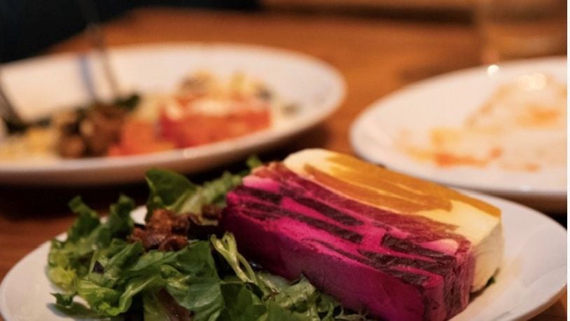 Kindred's beet terrine looks like a technicolor layer cake, with goat cheese stacked between red and gold beets. Courtesy of Alison Jakaitis