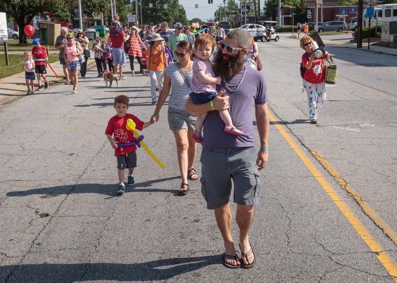 Children and their parents walk down Church Street during the kids parade that kicked off the Decatur Arts Festival on May 27, 2017. 