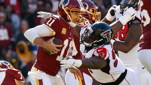 Washington Redskins quarterback Alex Smith (11) is sacked by Atlanta Falcons defensive tackle Grady Jarrett (97) in the first quarter at FedEx Field.