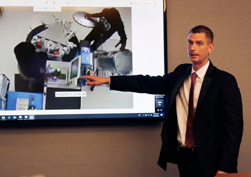 Colin Flynn, an investigator with Gwinnett County Police, with surveillance photos that show Eman Moss purchasing the trash can that his daughter's body was found in. The prosecution rested its case on April 26, 2019, the third day of the Tiffany Moss murder trial at Gwinnett County Superior Court.