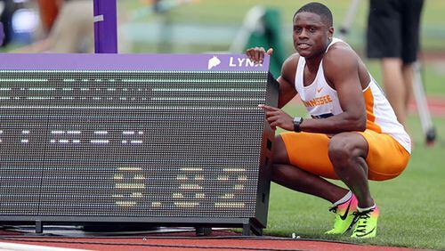 Christian Coleman poses next to his record time scoreboard Wednesday during the NCAA track and field championships at Hayward Field in Eugene, Oregon. Photo By Donald Page/Tennessee Athletics