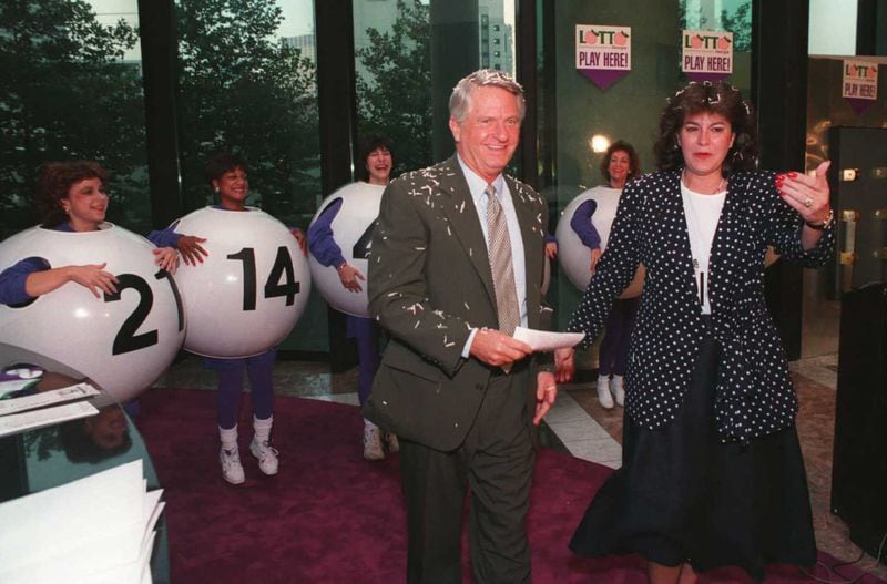 930910 - Atlanta, Georgia - Georgia's Governor, Zell Milleris led by lottery president Rebecca Paul to buy the first ticket for the Lotto Georgia game on Friday morning, September 10, 1993. (AJC Staff Photo/Dianne Laakso)
