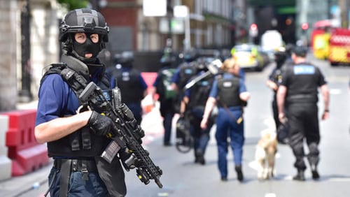Armed police on St Thomas Street, London, Sunday June 4, 2017, near the scene of Saturday night's terrorist incident on London Bridge and at Borough Market. Several people were killed in the terror attack at the heart of London and dozens injured. Prime Minister Theresa May convened an emergency security cabinet session Sunday to deal with the crisis. (Dominic Lipinski/PA via AP)