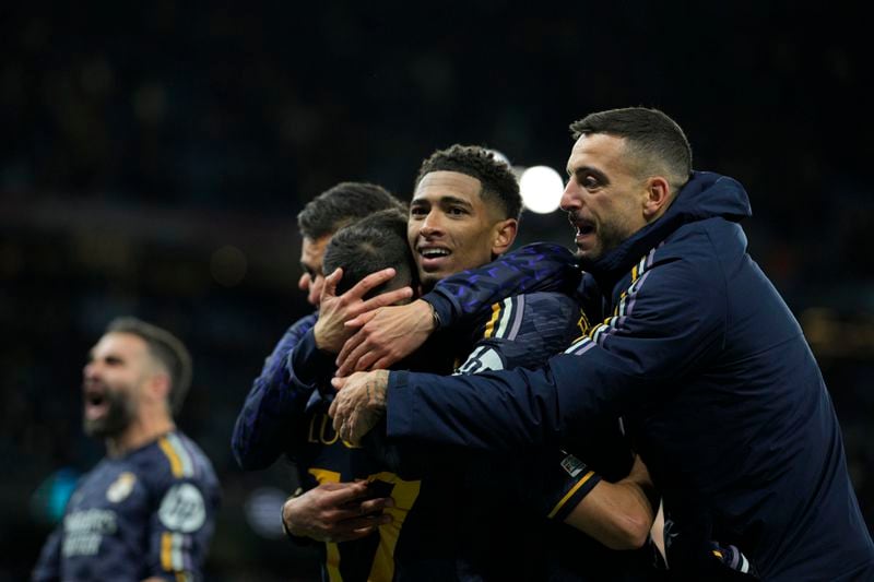 Real Madrid players celebrate at the end of the Champions League quarterfinal second leg soccer match between Manchester City and Real Madrid at the Etihad Stadium in Manchester, England, Wednesday, April 17, 2024. (AP Photo/Dave Shopland)