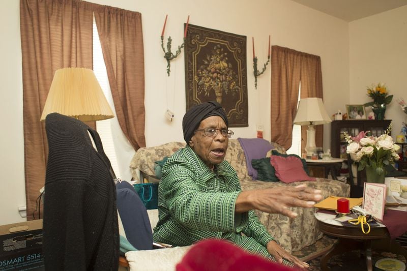 Calls from worried neighbors come through the phone that Helene Mills, 90, keeps beside her rocking chair. The lifelong resident of Atlanta’s Old Fourth Ward said one decided she would cut back on food to pay rising taxes. CHAD RHYM/ CHAD.RHYM@AJC.COM