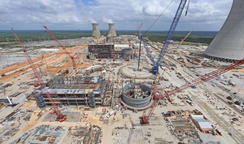 Steam rises from Plant Vogtle’s cooling towers for units 1 and 2, built in the 1970s and 1980s, while construction of units 3 and 4 continues. (Handout photo)
