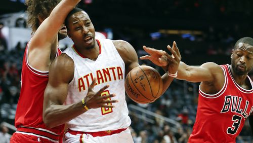 Atlanta Hawks center Dwight Howard (8) works against Chicago Bulls guard Dwyane Wade (3) and center Robin Lopez for the ball during the first half of an NBA basketball game Wednesday, Nov. 9, 2016, in Atlanta. (AP Photo/John Bazemore)