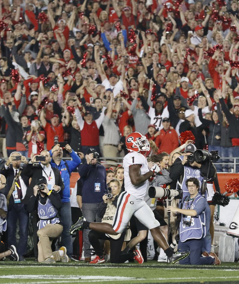 Georgia running back Sony Michel scores the winning touchdown in overtime at  the college football playoff Semifinal at the Rose Bowl Monday .
