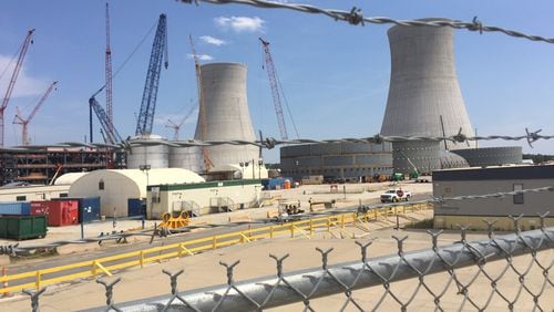 Two new cooling towers and construction cranes mark the work sites for nuclear reactors 3 and 4 at Plant Vogtle in east Georgia. The project is currently $3.6 billion over budget and almost four years behind the original schedule. JOHNNY EDWARDS / JREDWARDS@AJC.COM