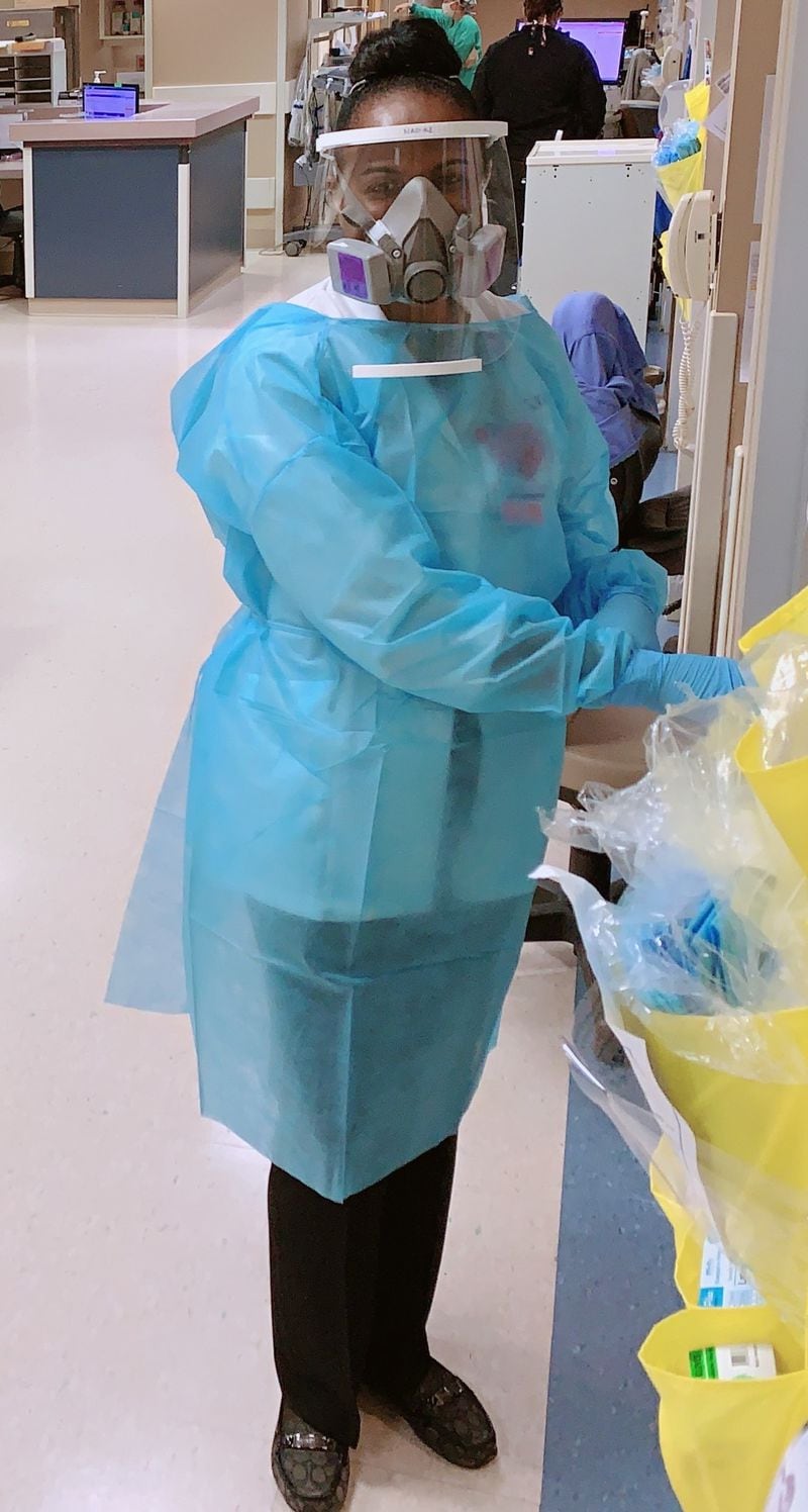 Nadine Lynch dons personal protective equipment before checking on a patient at Wellstar Kennestone Hospital. (Courtesy of Wellstar Kennestone Hospital)
