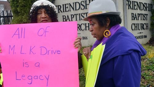 Carrie Savary (left) and Yvonne Jones joined other members of the Westside Neighborhoods Coalition at a press conference and rally at the corner of MLK Drive and Northside Drive Wednesday. Residents want more detailed plans about how the road will be rerouted when the new Falcons stadium is built.