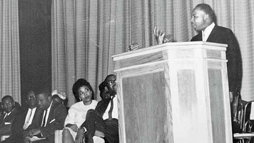 Dorothy Cotton as a young woman listens to a speech by Martin Luther King Jr.