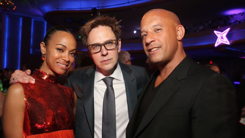 Actors Zoe Saldana (L) and Vin Diesel (R) are among the "Guardians of the Galaxy Vol. 3" costars who signed an open letter asking that James Gunn (C) be reinstated as the franchise's director. Gunn was fired after some of his offensive tweets resurfaced. (Photo by Jesse Grant/Getty Images for Disney)