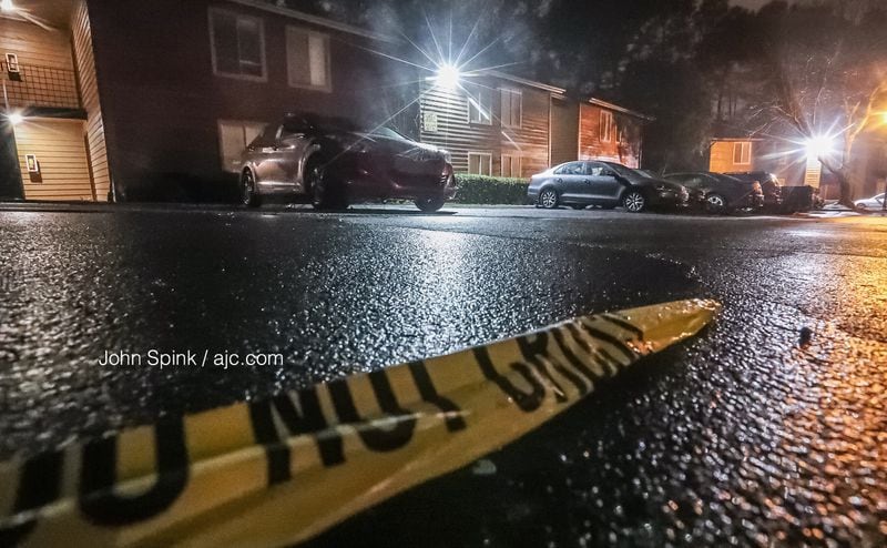 A piece of crime scene tape remains at the scene of a deadly shooting at a Doraville area apartment complex Friday morning. JOHN SPINK / JSPINK@AJC.COM