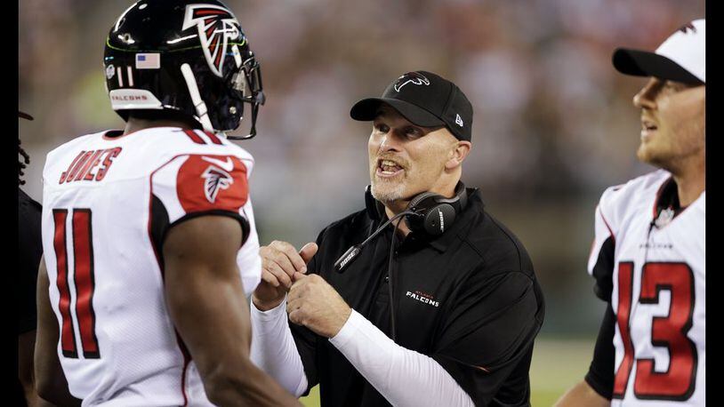 Falcons coach Dan Quinn encourages Julio Jones (11) during the first half Friday against the Jets. (AP Photo/Peter Morgan)