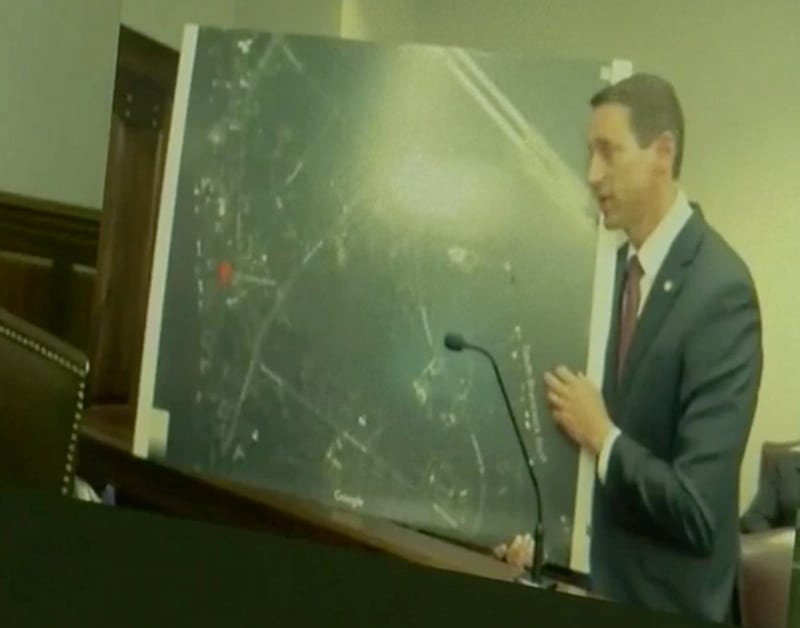 Jesse Evans, a prosecutor with the Cobb County District Attorney’s Office, shows a magnified photo of the neighborhood where Ahmaud Arbery was fatally shot.