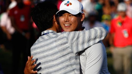 It’s Fathers Day, too, at the Players Championship Sunday as Si Woo Kim celebrates his championship with his dad on the 18th green. (Sam Greenwood/Getty Images)