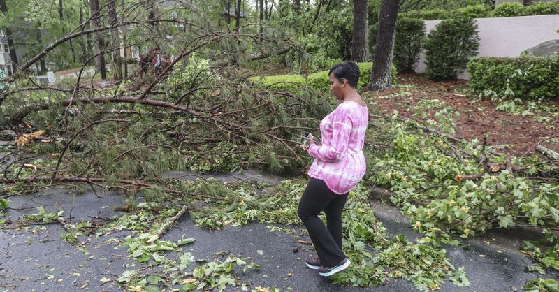May 3, 2021 Atlanta: Atlanta Mayor Keisha Lance Bottoms surveys the damage on New Britain Drive in her neighborhood after a severe thunderstorm swept through the city on Monday morning May 3, 2021. A possible tornado tracked on the ground for several miles, starting in Douglas County and moved northeast through the city into northern DeKalb County, according to Channel 2 Action News meteorologists. The National Weather Service will conduct a survey to confirm the tornado and determine its strength. In Atlanta, fire crews responded to a number of calls for trees down on homes and on the streets along the Cascade Road corridor. (John Spink / John.Spink@ajc.com)

