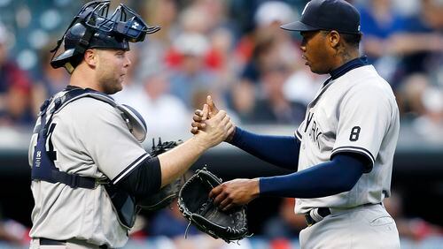 New York Yankees catcher Brian McCann, left, and Aroldis Chapman celebrate a win in 11 innings against the Cleveland Indians on Saturday, July 9, 2016, in Cleveland. (AP Photo/Ron Schwane)