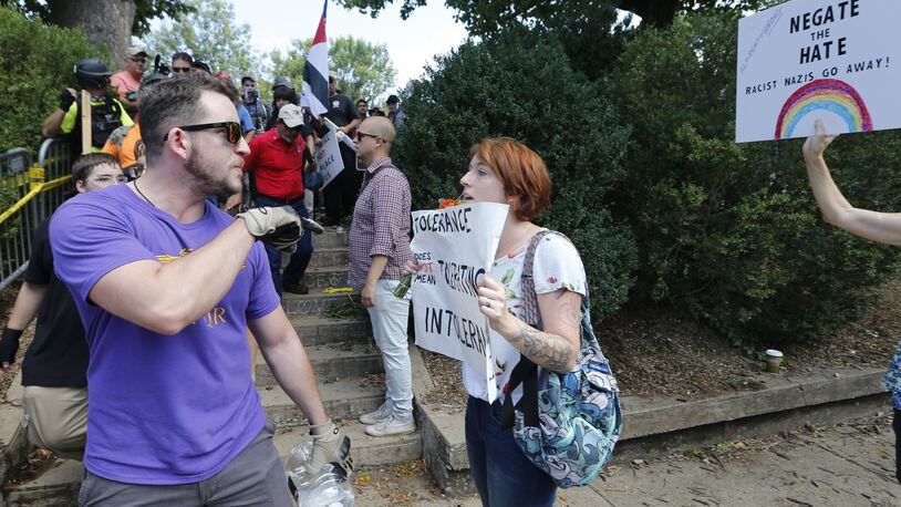 This 2017 image shows a white supremacist, left, being confronted by a counter demonstrator at a rally in Charlottesville, Va. Many worry incidents of hate crimes and bigotry are on the rise in the face of the coronavirus epidemic. (AP Photo/Steve Helber)