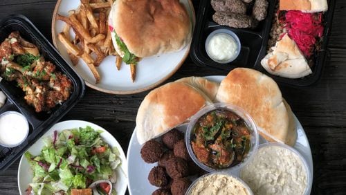 A feast from Cafe Raik in Duluth features (clockwise from top): shawafel sandwich with hand-cut fries; beef kababs with mejadara; appetizer assortment, fattoush salad; and fried cauliflower. Wendell Brock for The Atlanta Journal-Constitution