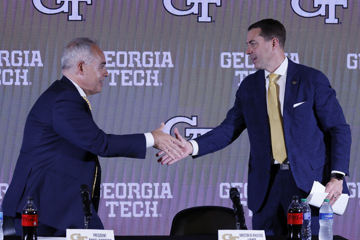Georgia Tech President Angel Cabrera shakes hands with new athletic director J Batt during a news conference Monday. (Miguel Martinez / miguel.martinezjimenez@ajc.com)