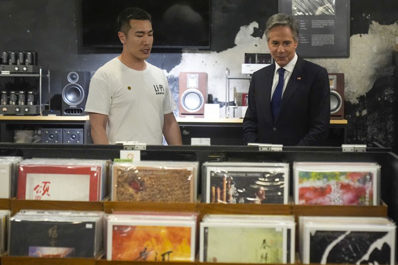 U.S. Secretary of State Antony Blinken talks with Yuxuan Zhou during a visit to Li-Pi record record store in Beijing, China, Friday, April 26, 2024. (AP Photo/Mark Schiefelbein, Pool)