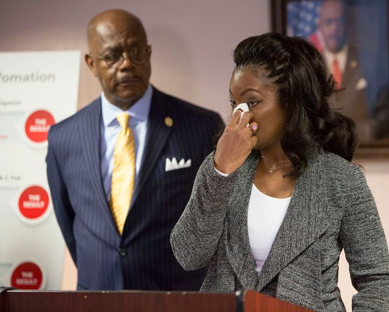 Fulton County District Attorney Paul L. Howard, Jr (left) listens as Monteria Robinson talks about the death of her son Jamarion Robinson. Howards announced the filing of a lawsuit against the United States Department of Justice in the death of her son during a press conference on December 28th, 2018. (Photo by Phil Skinner)