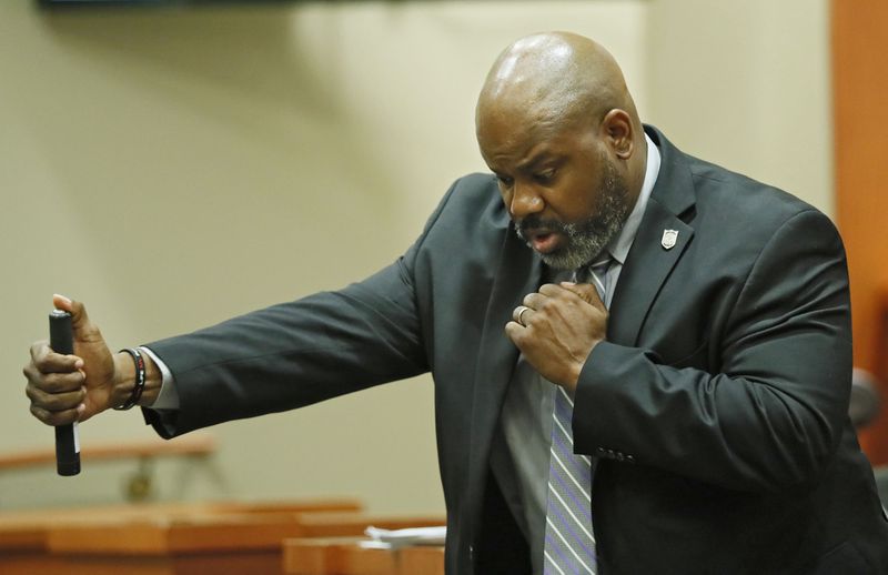 October 2, 2019 - Decatur -   DeKalb Police Sgt. J.K. Walker testifies about DeKalb Police use of force policies and demonstrates the use of an expandable baton.  Former DeKalb County police officer Robert "Chip" Olsen is on trial for murder in the 2015 shooting of war veteran Anthony Hill.  Bob Andres / robert.andres@ajc.com
