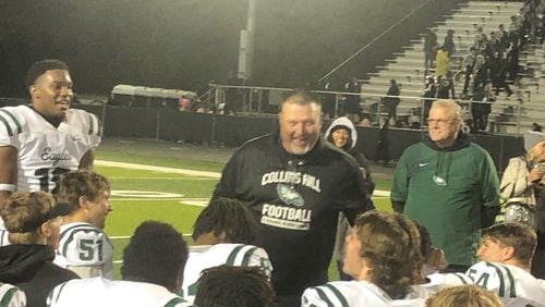 Collins Hill coach Lenny Gregory talks to his team after a 40-10 win over Mill Creek on Oct. 30, 2021.  The win gave the No. 1-ranked Eagles an undefeated season and a second straight Region 8 championship.