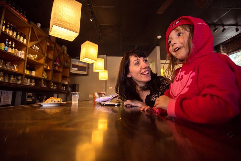 Jen Smith and 4-year-old Louise Smith, dressed as Owlette from PJ Masks, of Druid Hills enjoy an afternoon at Kavarna, a family friendly coffee shop, tavern, music venue and exhibition space in Oakhurst.  (Jenni Girtman / Atlanta Event Photography)